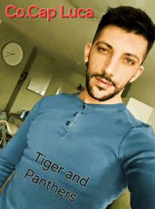 a man wearing a blue shirt that says " tiger and panthers "