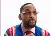 a man wearing a colorful sweater and tie