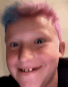 a close up of a child 's face with pink and blue hair .