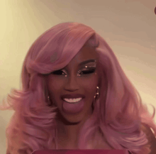 a close up of a woman with pink hair sticking her tongue out