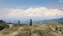 a person standing on top of a hill looking at a city