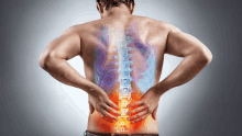 a man is holding his back in pain with a drawing of the spine in the background