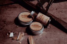 a bottle of lone stranger beard oil sits next to a bottle of beard balm