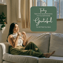 a woman sits on a couch with a sign that says today take a few quiet moments