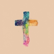 a colorful cross with a rainbow colored background on a beige background .