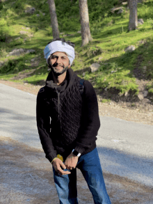 a man wearing a turban and a black sweater