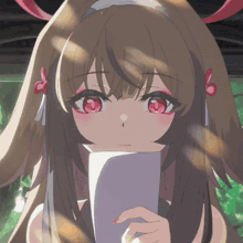 a girl with long brown hair and red eyes holds a piece of paper