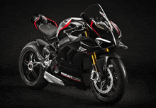 a black ducati corse motorcycle is sitting on a black surface