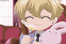 a boy is holding a stuffed animal and eating something with a fork