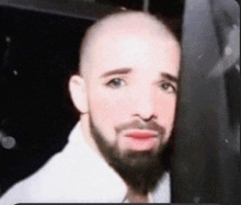 a man with a beard and a bald head is wearing makeup