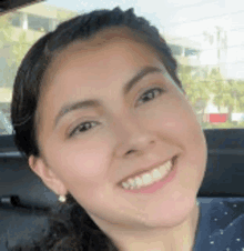 a close up of a woman 's face with a smile on her face .