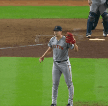 a baseball player wearing a boston jersey throws a ball