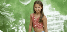 a young girl in a crop top is standing in front of a pond