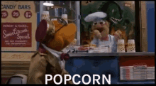 a muppet is selling popcorn in front of a sign that says senior citizens special