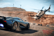 a helicopter is flying over a car in need for speed payback