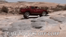 a red truck is driving down a rocky cliff with the words `` time too fly off cliff '' .