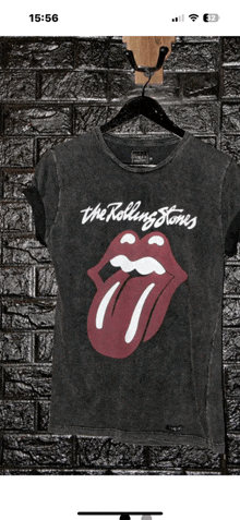 a black rolling stones t-shirt is hanging on a black hanger