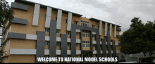 a large building that says welcome to national model schools on it