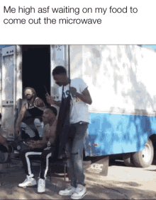 a group of men are standing in front of a blue and white truck that says cdc on the side of it