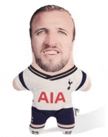 a stuffed toy of a man with a beard wearing a tottenham hotspur shirt .