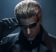 a man wearing sunglasses and a black jacket looks down