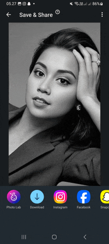 a black and white photo of a woman is displayed on a cell phone