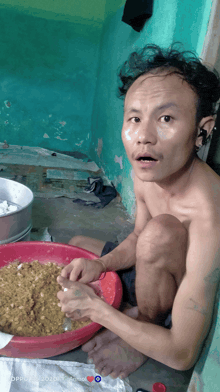 a man is kneeling down in front of a bowl of food with the words oppo on the bottom right