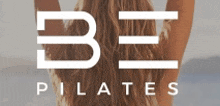 a woman with her arms in the air is standing in front of a be pilates logo .