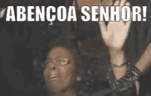 a woman is waving her hand in front of another woman and the words abencoa senhor .