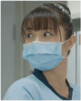 a close up of a woman wearing a blue mask