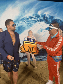 a man in a red adidas jacket holds a towel in front of a beach scene