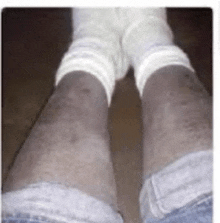 a close up of a person 's legs with socks on .