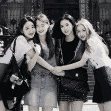 a group of young women are posing for a black and white photo .