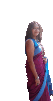 a woman in a purple and blue saree is smiling