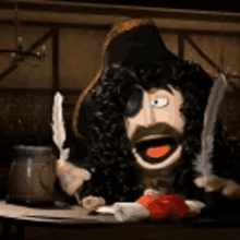 a pirate puppet is sitting at a table with two feathers in his hand