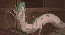 a drawing of a white and green dragon with a long tail