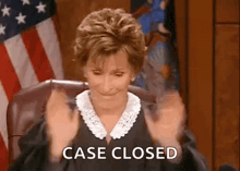 a judge is sitting in a courtroom with her hands in the air and the words `` case closed '' written on her face .