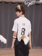 a young man wearing a white shirt with the number 8 on it