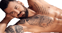 a shirtless man with a tattoo on his chest