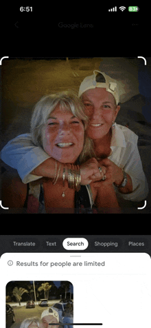 a phone screen shows a picture of two women and the words results for people are limited on the bottom