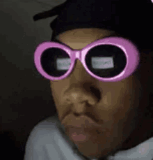 a close up of a person wearing pink sunglasses .