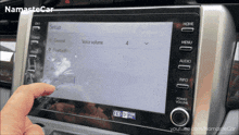 a person is adjusting the volume of a car stereo