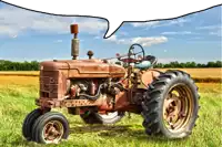 an old rusty tractor is parked in a grassy field