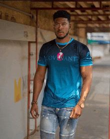 a man wearing a blue and black shirt that says covenant