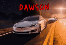 a white tesla model s is driving down a desert road at night .