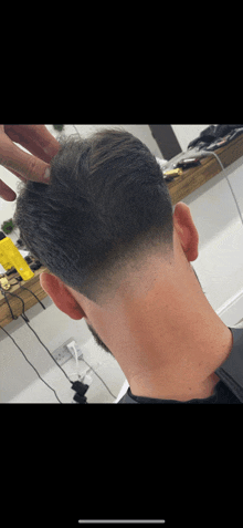 the back of a man 's head with a very short haircut