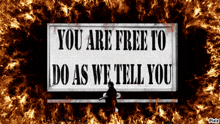 a sign that reads " you are free to do as we tell you "