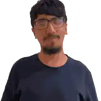 a man with a beard wearing glasses and a black shirt