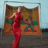 a woman in a red dress stands in front of a sign that says monky rodeo