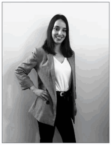 a black and white photo of a woman in a blazer and white shirt